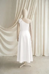 Mara Ivory satin junior bridesmaid dress by TH&TH — back view of the A-line skirt