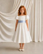 Poppy ivory matte satin flower girl dress by TH&TH with a removable french blue satin sash tied in a bow, front view