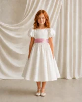 Poppy ivory matte satin flower girl dress by TH&TH with a removable smoked blush satin sash tied in a bow, front view