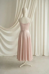 Tilly Blush Pink satin junior bridesmaid dress by TH&TH — back view of the full tea-length skirt